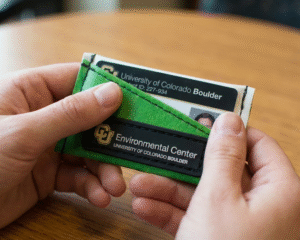 Upcycled CU Boulder ID wallets made from recycled campus banners for the Environmental Center.